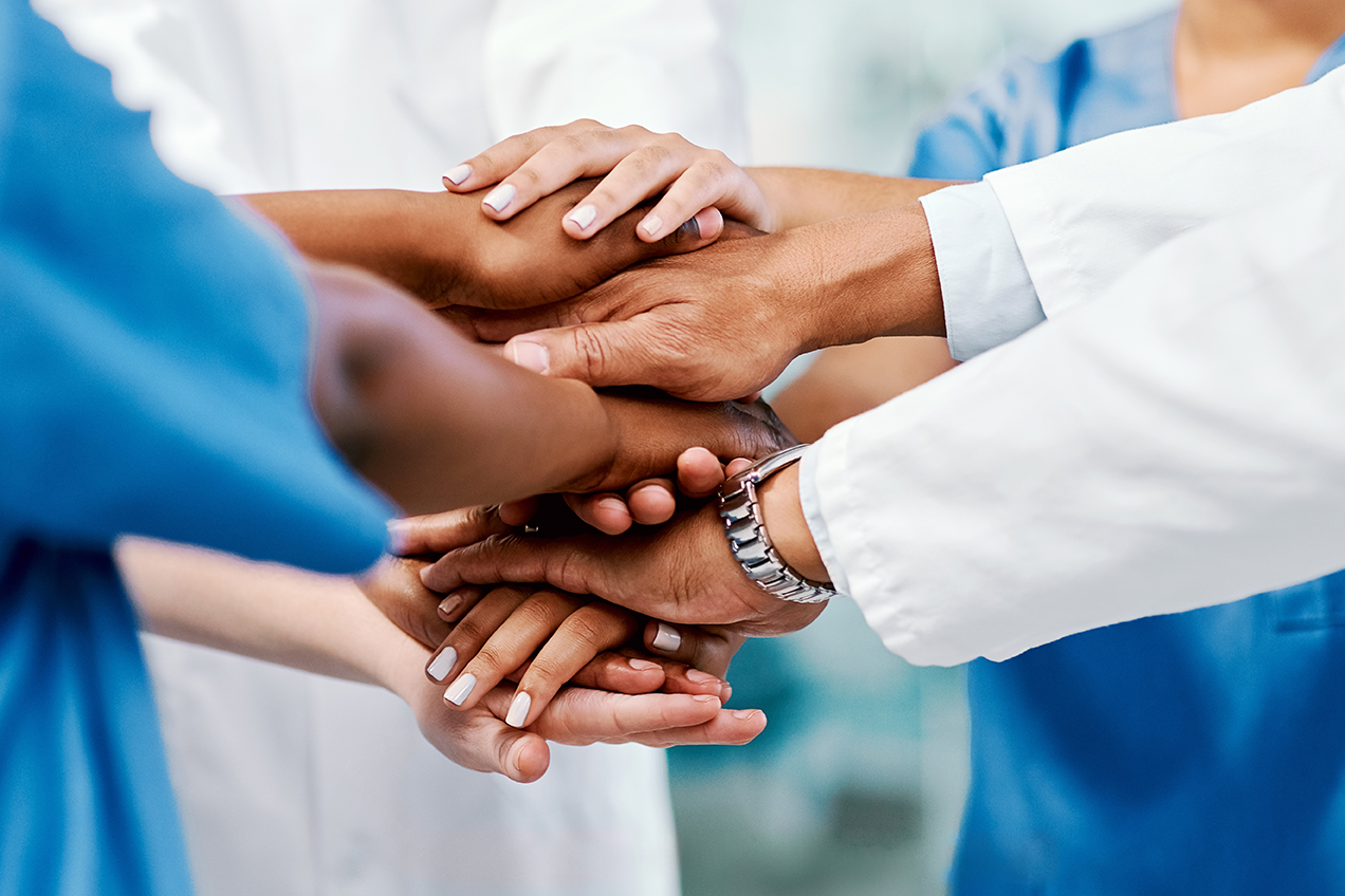 Team of clinicians in a huddle.