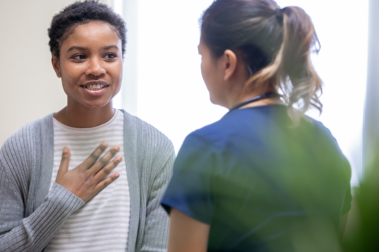 Woman speaking to clinician.