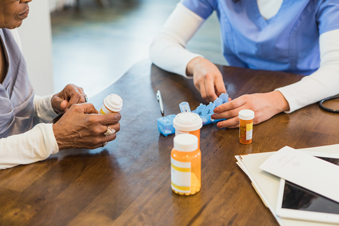 Pharmacist is assiting a patient with medication