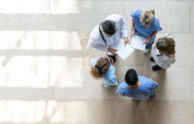 Overhead image of providers standing in a circle while talking