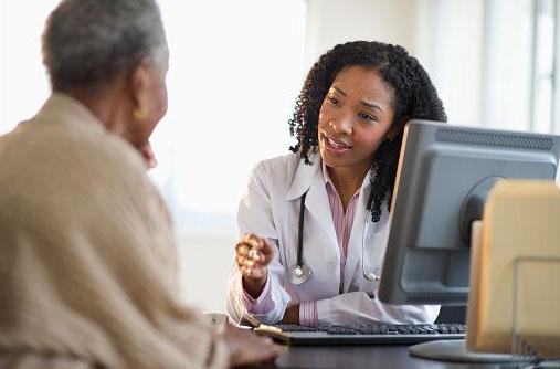 Female provider and Female Patient Sitting at a Desk at a Computer