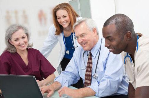 Clinical Team Surrounding Computer