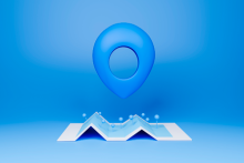 Blue GPS pin floating over an unfolded map